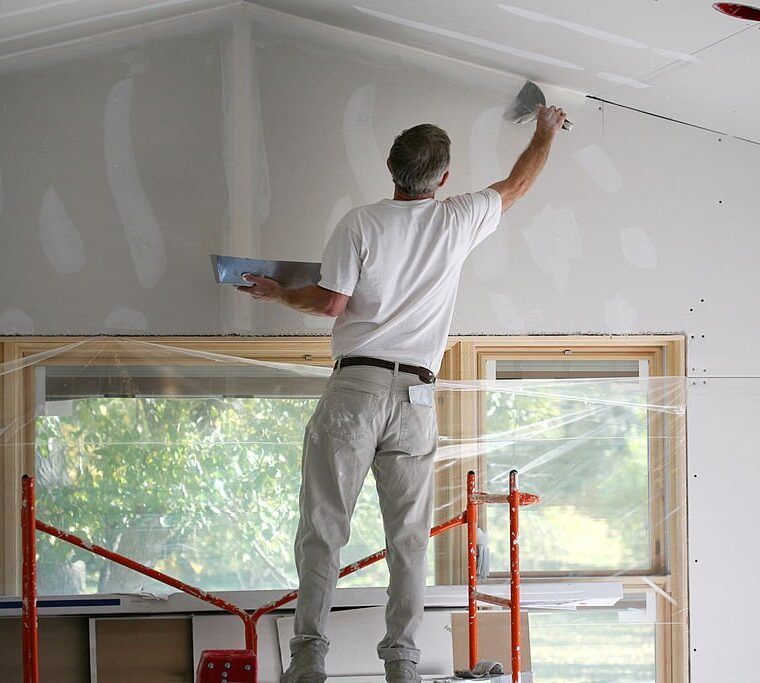 Applying mud to freshly taped sheetrock.