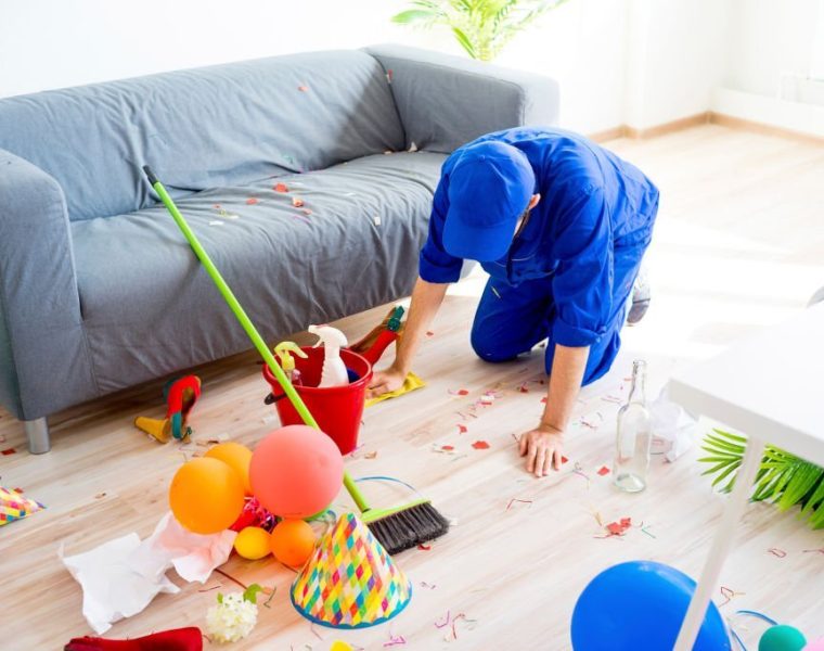 A janitor is cleaning a mess after a party